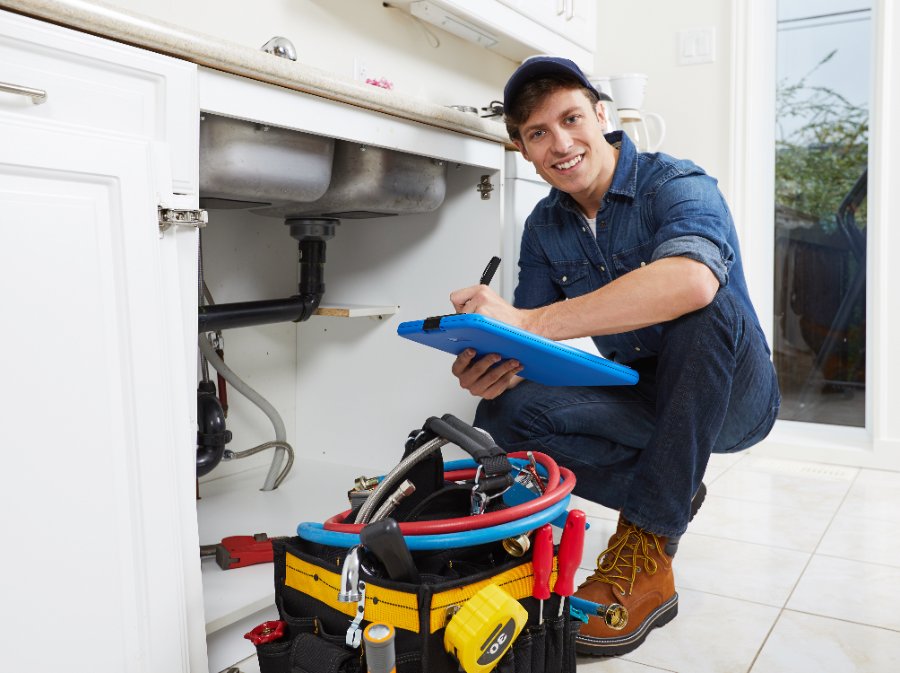 Licensed plumber documenting an under-sink inspection at a Corona home
